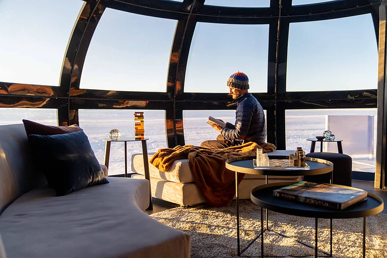 A visitor inside a comfy Echo cabin - Copyright: Andrew Macdonald for White Desert
